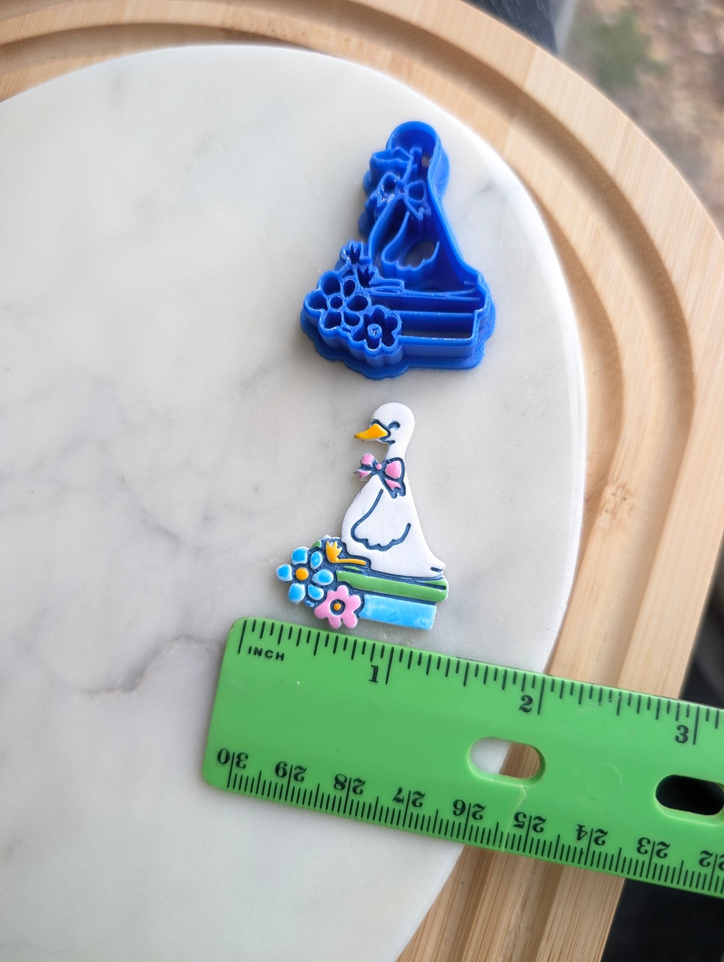 Goose Wearing a Bow Sitting on Books with Flowers Sharp Clay Cutter