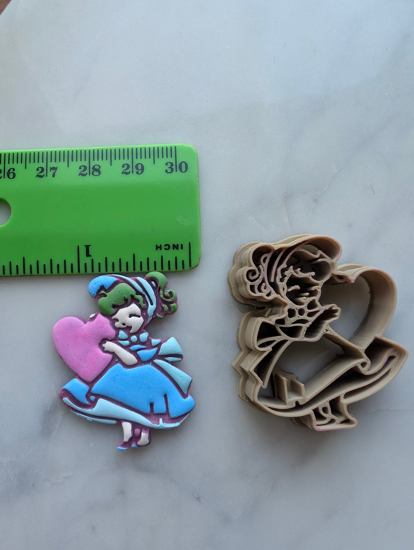 Vintage Girl in Full Dress Holding a Heart Sharp Clay Cutter