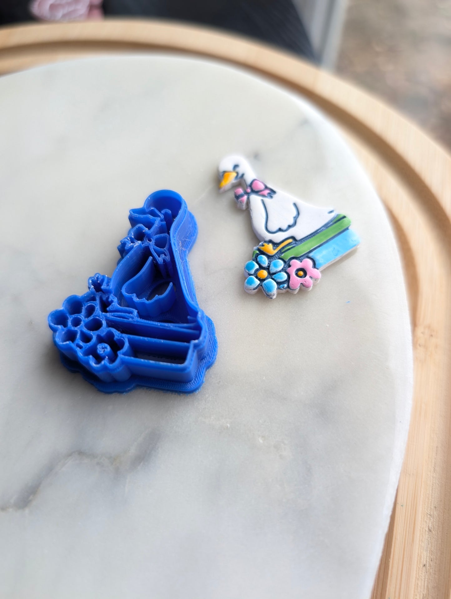 Goose Wearing a Bow Sitting on Books with Flowers Sharp Clay Cutter
