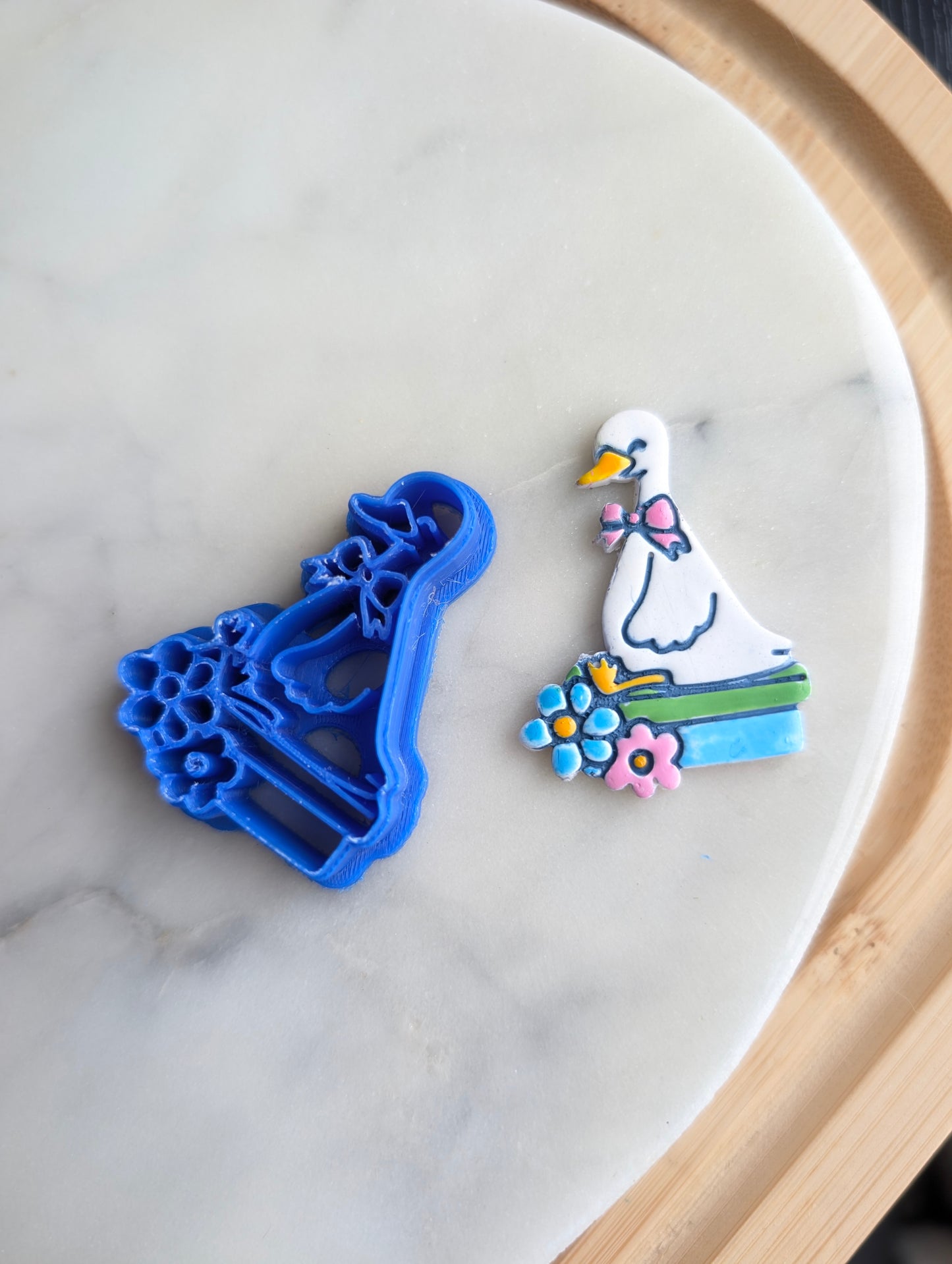 Goose Wearing a Bow Sitting on Books with Flowers Sharp Clay Cutter