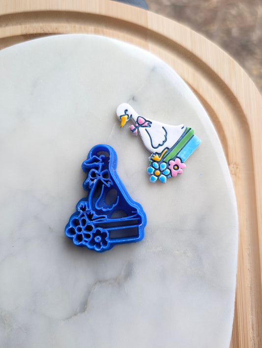 Goose Wearing a Bow Sitting on Books with Flowers Sharp Clay Cutter